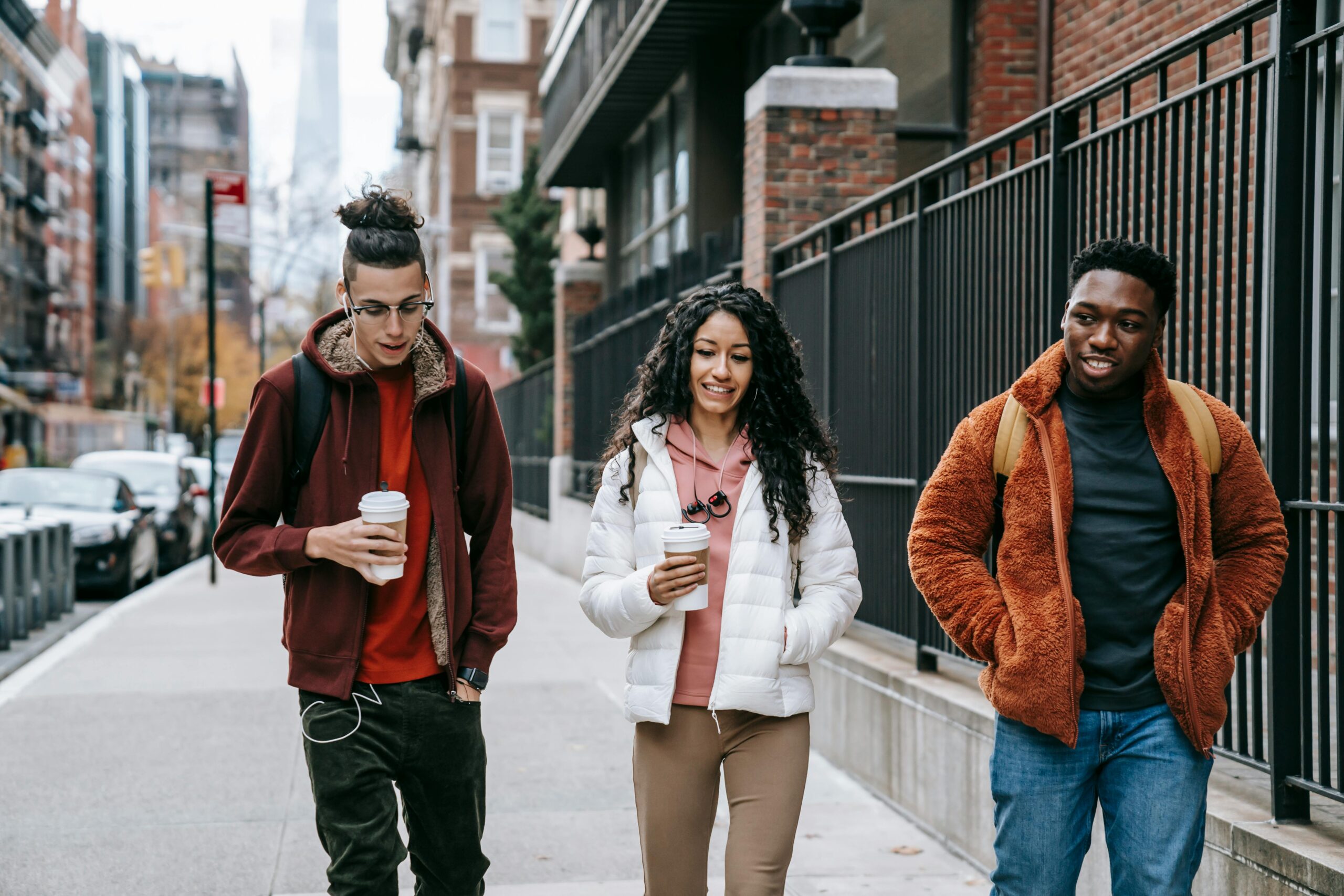 Budget Van Rental NYC in 2025: Your Handy Guide to Hauling Your Crew 2 Young glad multiracial partners with hot drinks to go strolling on urban pavement in daytime