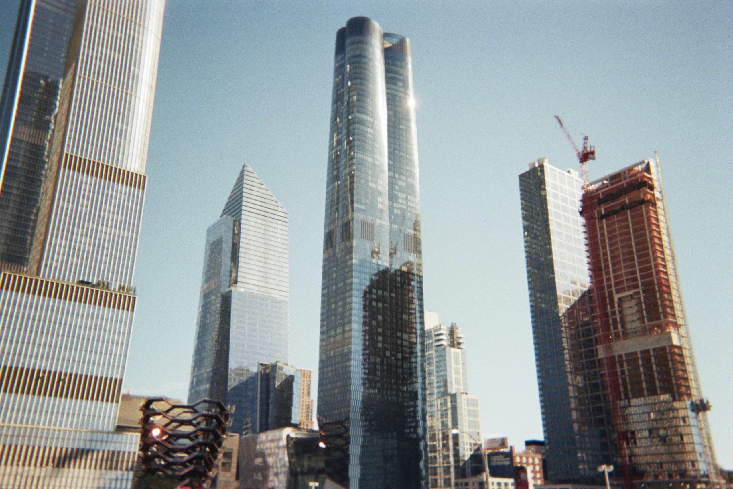 A breathtaking view of modern skyscrapers in New York City against a clear blue sky.