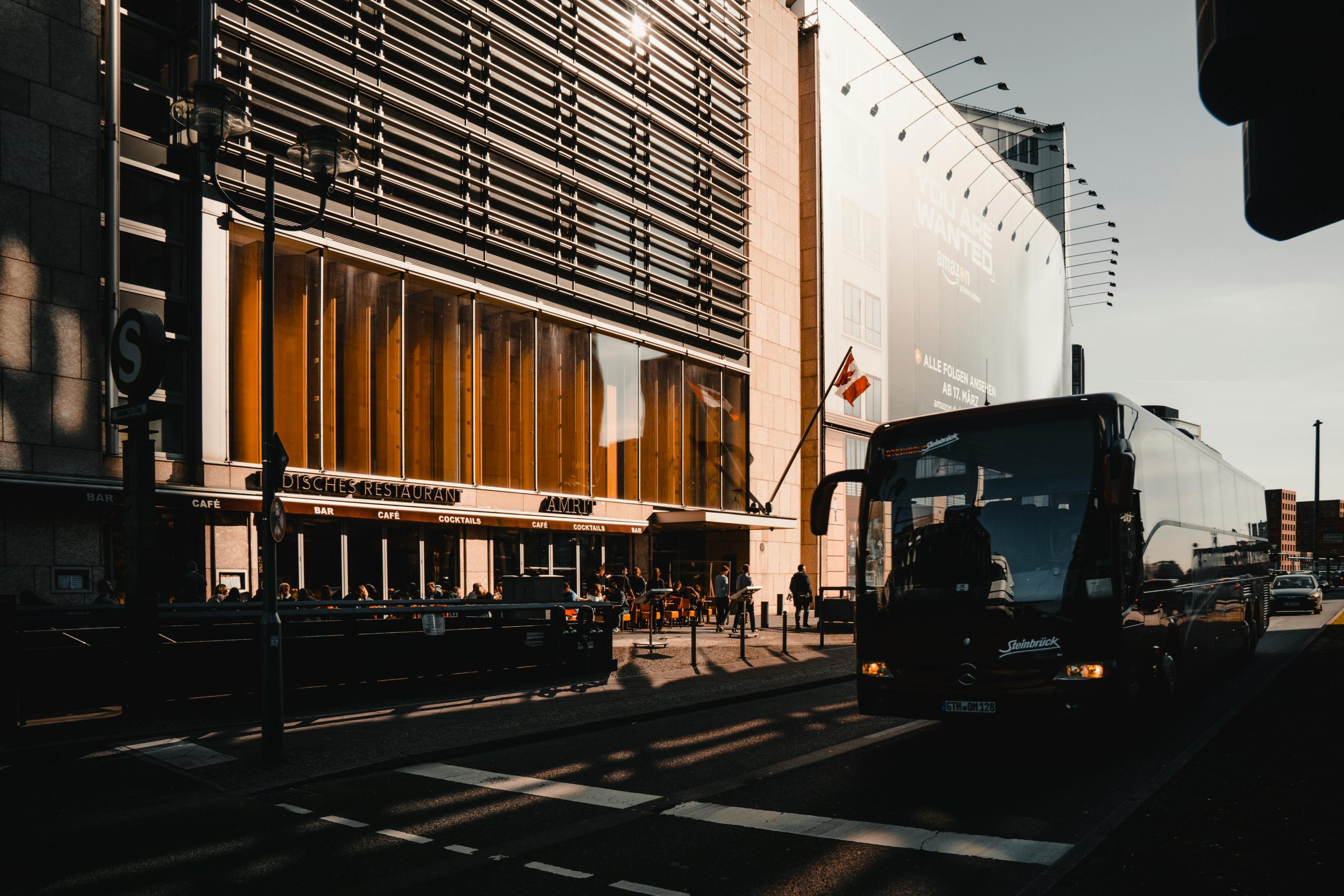 Best Charter Bus Company NYC: 5 Honest Options for Corporate Groups in 2026 2 Busy urban street in Berlin with a bus and modern architecture during the day.