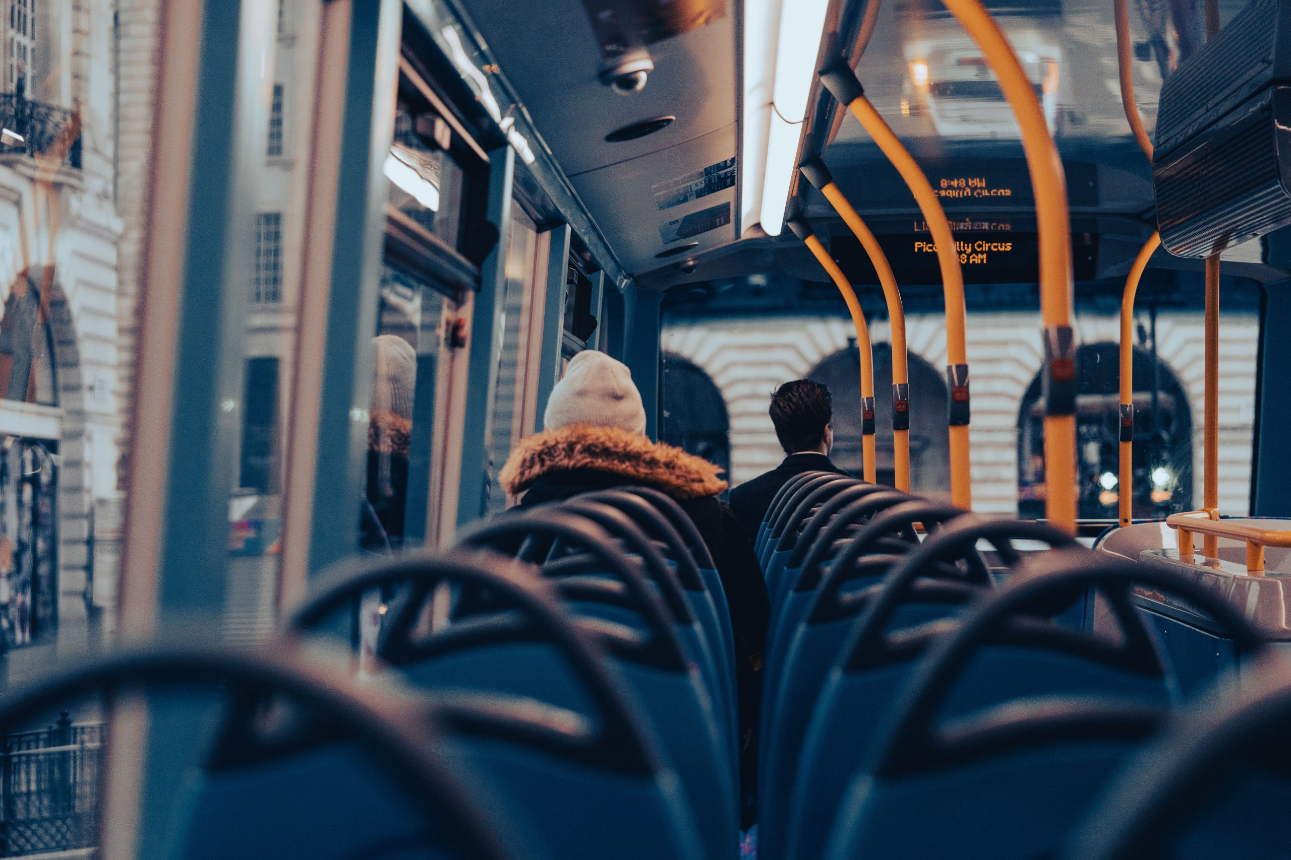 Charter Bus Rental NYC: 6 Seasonal Booking Truths for Corporate Events in 2026 2 Passengers traveling on a city bus through London, capturing urban commuting life.