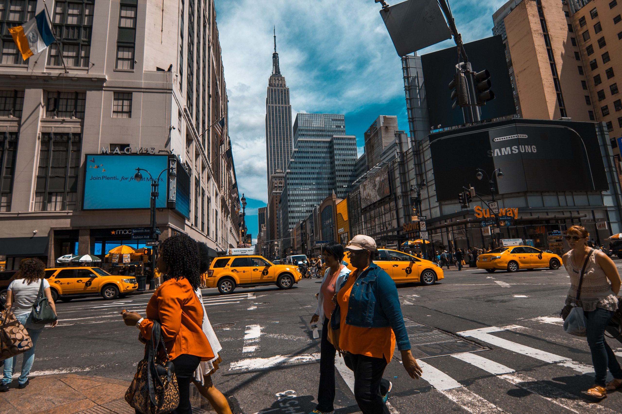 Group Transportation NYC: 6 Proven Seasonal Truths for Construction Sites in 2026 2 Bustling New York City street with yellow cabs and pedestrians crossing