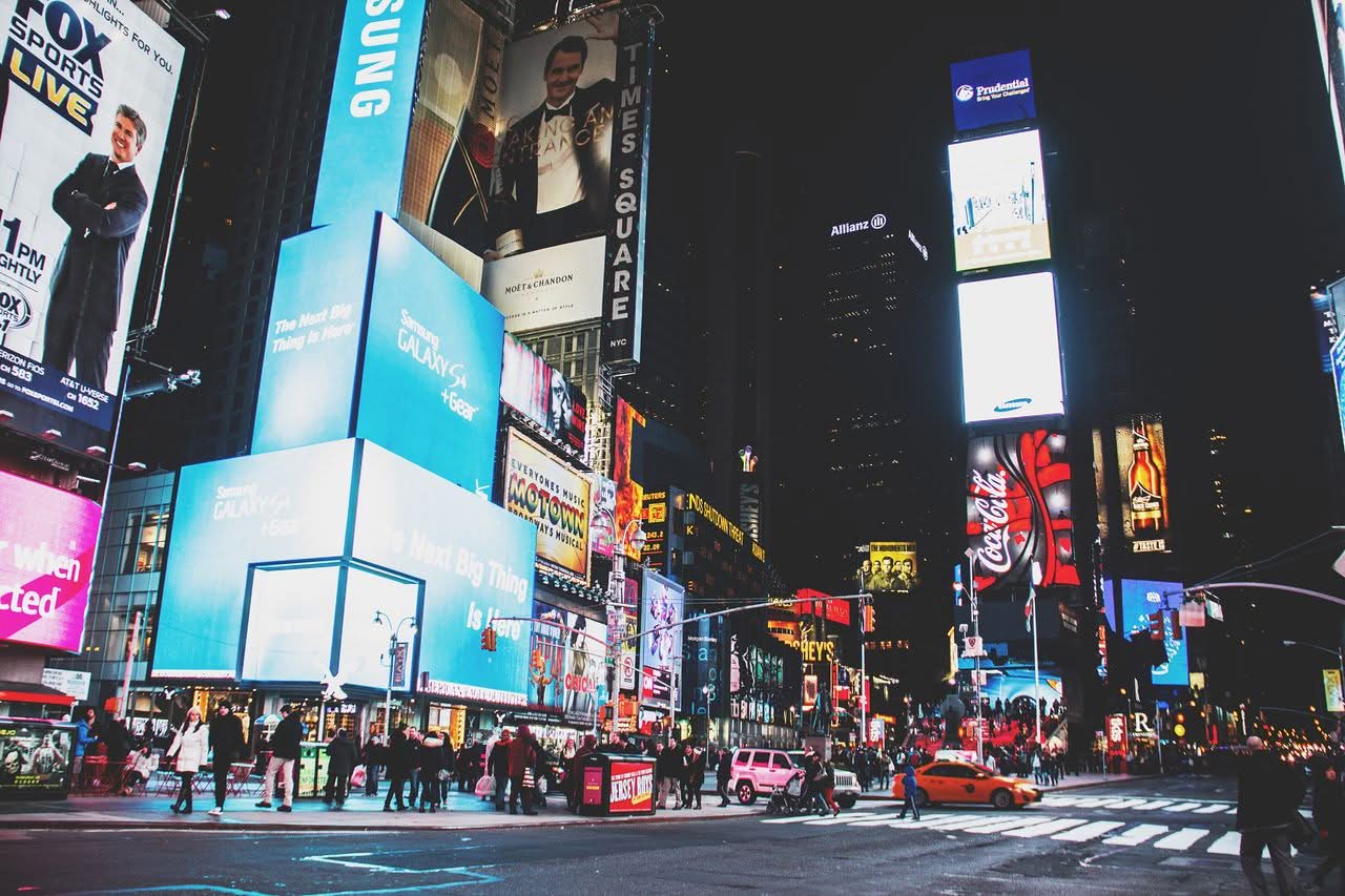 Bus Companies NYC for Events: A Trusted 2026 Booking Guide 8 Dynamic night scene with neon lights and bustling crowds in Times Square, New York City.