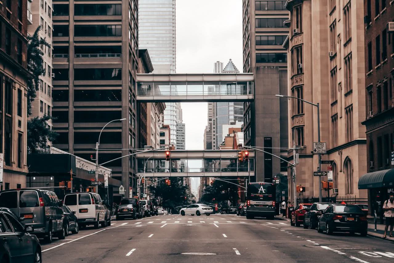 Wedding Transportation NYC Tips: 7 Honest Picks for 2026 10 Dynamic view of a busy New York City street with traffic and towering skyscrapers.