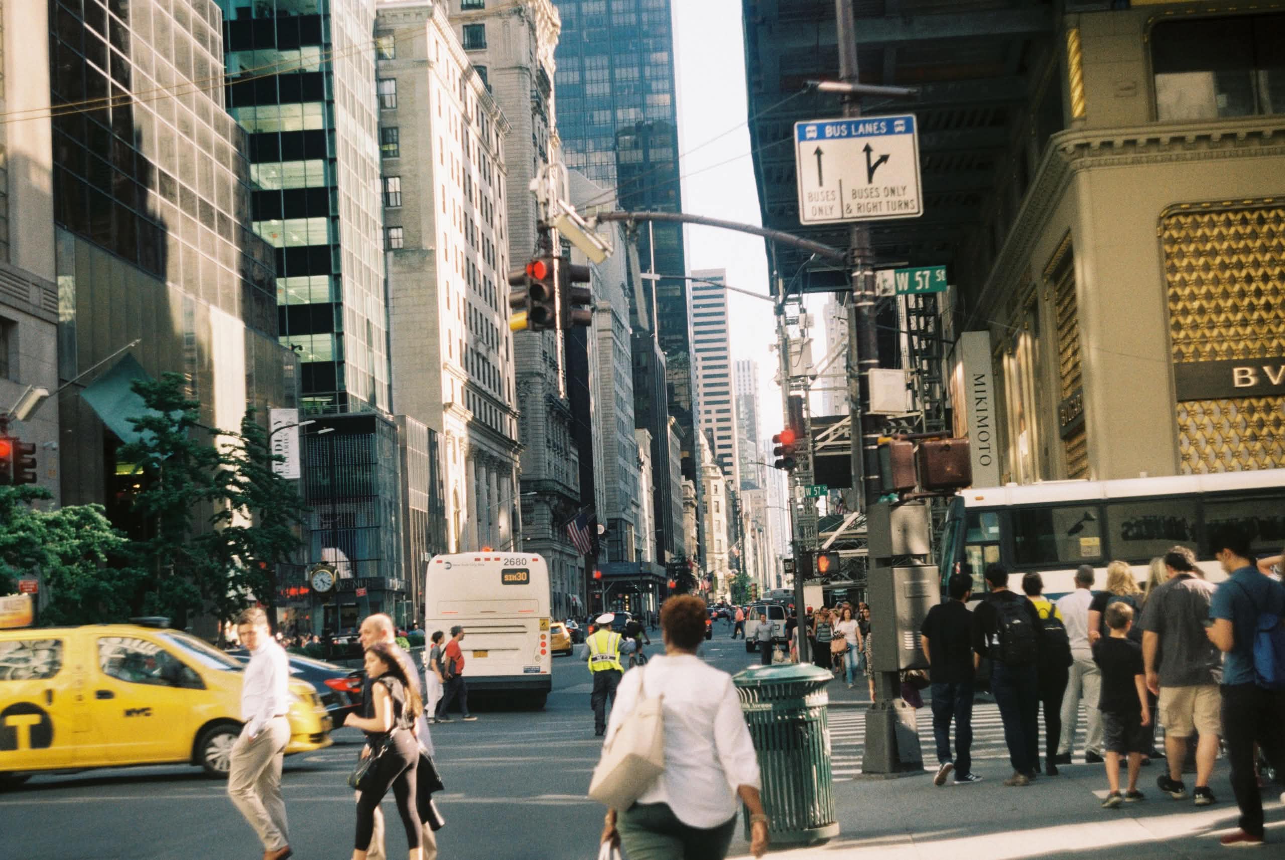 How Much Are Charter Buses in NYC? The Honest 2026 Numbers 7 Crowd of people on crosswalk passing road in busy day in city downtown